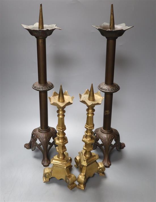 A pairs of brass pricket candlesticks, height 40cm and a pair of bronze pricket candlesticks, height 25cm